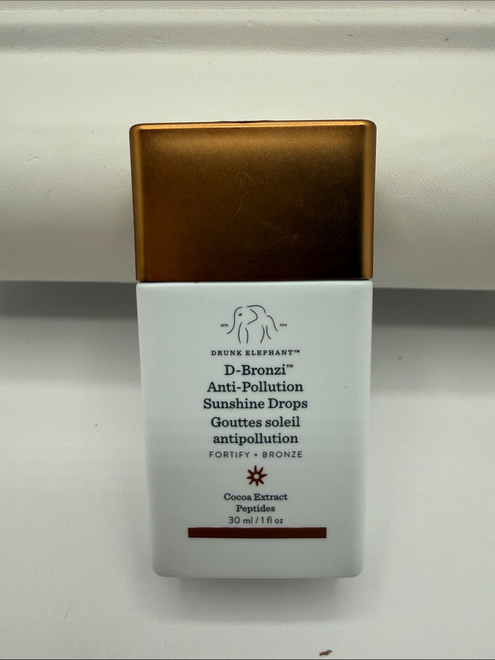 Drunk Elephant D-Bronzi Anti-Pollution Sunshine Drops — Bronze & White Bottle